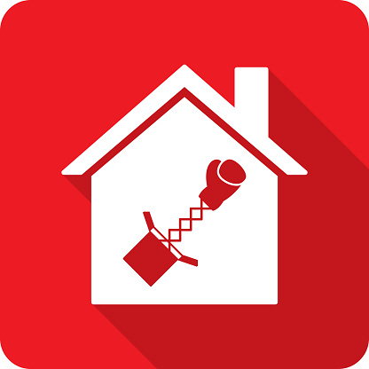 Vector illustration of a house with boxing glove extending out of box against a red background in flat style.