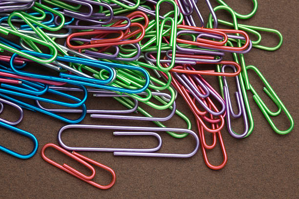 istock Colorful Paper Clips on Brown Background 176027247