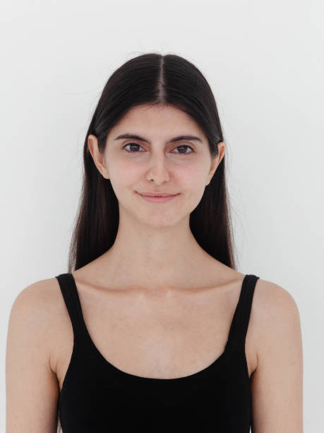 Happy Beautiful young woman smiling looking super cute Close-up Portrait Mixed race ethnicity Persian White girl with no make-up Big brown eyes Long black straight hair Studio shot on white background Front view looking at camera wearing black top Perfect example of fashion model digitals for modeling agency application hermosa mujer joven sonriendo luciendo linda retrato de primer plano etnia de raza mixta persa chica blanca sin maquillaje grandes ojos marrones pelo largo y liso negro disparo de estudio sobre fondo blanco modelos de moda digitales con top negro sin manga