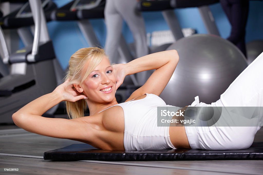 Smiling Girl Exercise in the Gym Closeup of young attractive fitness girl exercising in gym, 14th Jun 2009 Gym Stock Photo