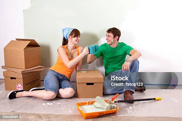 Young Couple Drink Coffee While Painting Wall Diy Home Improvement Stock Photo - Download Image Now