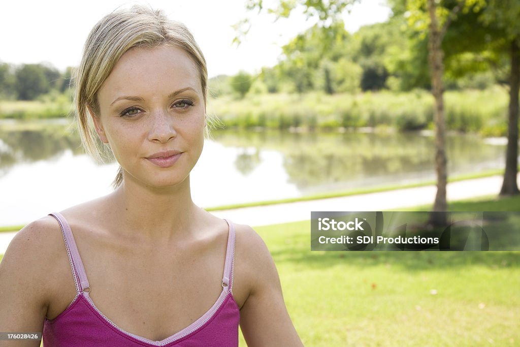 Young Caucasian Woman at a Park Happy Young Caucasian Woman at a Park.See more from this series: 20-24 Years Stock Photo