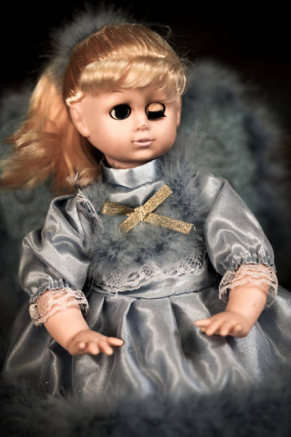 Strange doll winking stock photo