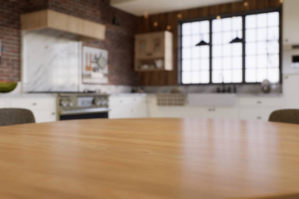 istock Kitchen with an emphasis on the surface of the kitchen table with a blurred background - a place to place products. L-shaped kitchen with beams and dining table. 3D rendering 1760298798