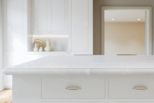 istock Kitchen white countertop with white marble, with blurred bokeh background. Presentation of goods in the kitchen interior on the countertop surface. 3D rendering 1760299312
