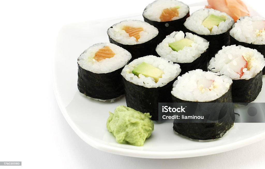maki sushi "salmon, avocado and crab stick makizushi with wasabi and pickled ginger on a plate" Wasabi Stock Photo