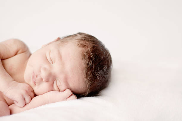 istock Newborn Baby Boy Sleeping Peacefully 176030234