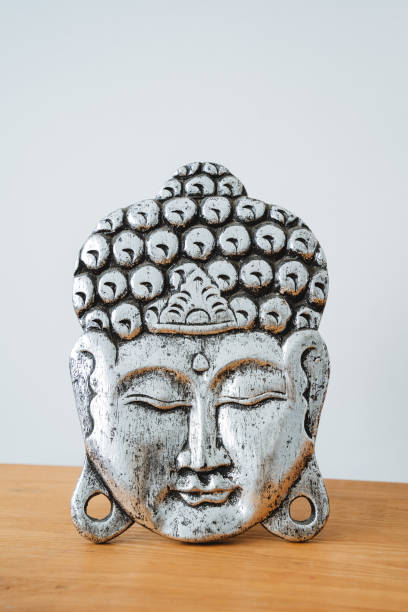 istock A silver-colored Buddha's head stands on a table. Depiction of the deity Asia 1760310273