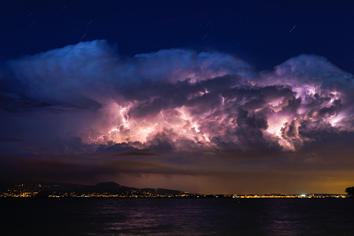 Little Lightnings in a Thunderstorm-Cloud over the Lake Garda in Italy