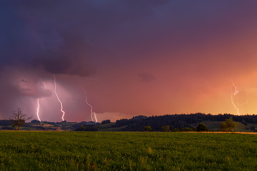 Lightning Strkes during a Thunderstorm with Sunset in Switzerland