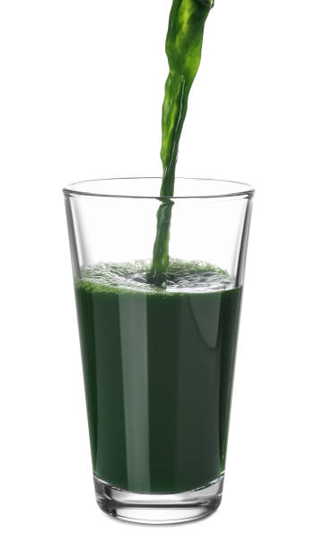 istock Pouring fresh juice into glass on white background 1760332009