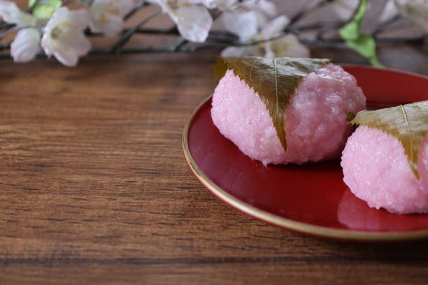 istock Rice cake with bean paste wrapped in a preserved cherry leaf on a lacquered board. 1760338311