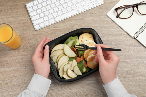 istock Office employee having business lunch at workplace, top view 1760347714