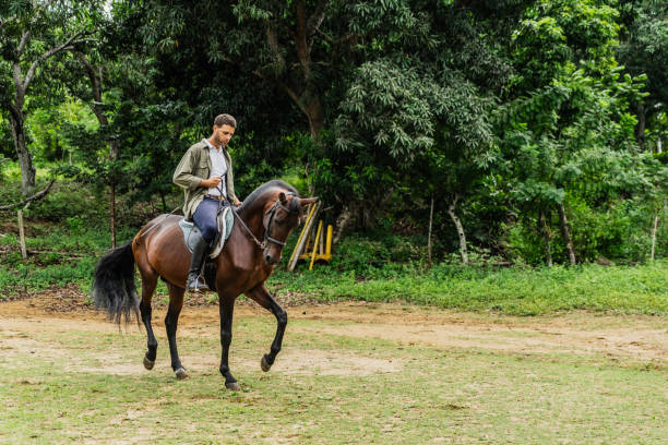 istock Mid adult man horseback riding at ranch 1760355754