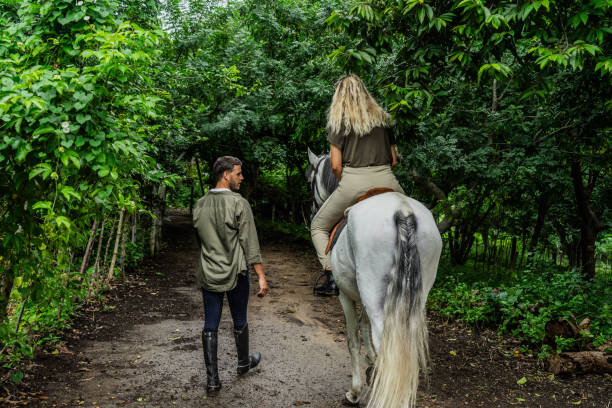 istock Couple horseback riding at the ranch 1760356307