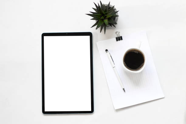 istock Mock up digital tablet with blank screen, coffee, plant and white notebook on white office desk. Flat lay, top view. 1760367736