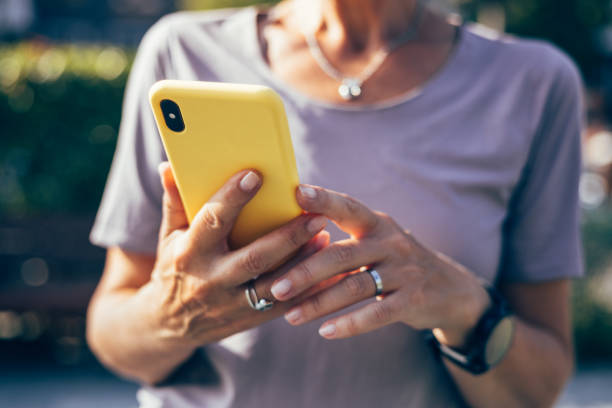 istock Anonymous Woman Taking a Break from Jogging and Checking Her Mobile Phone 1760412663