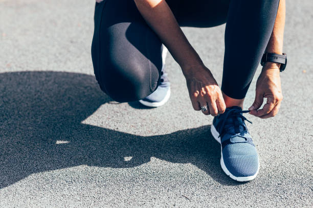 istock Anonymous Woman Tying Her Shoelaces Before Her Outdoors Training 1760412673