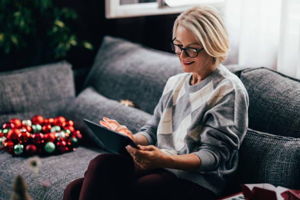 Tablet in Hand: Senior Woman's Online Christmas Shopping