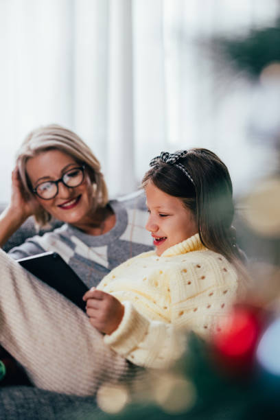 istock Festive Bonding: Granddaughter Draws on a Tablet with Grandma 1760419490