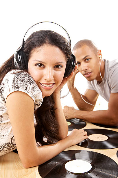 Directly Above Shot Of Black Headphones With Heart Shape Toy On Yellow Background