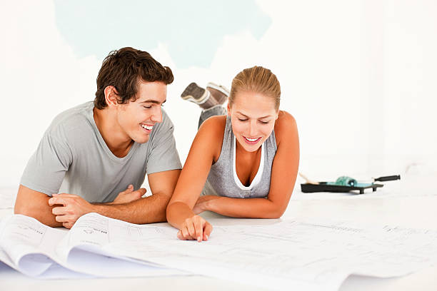 istock Couple lying on the floor with blue prints 176042181
