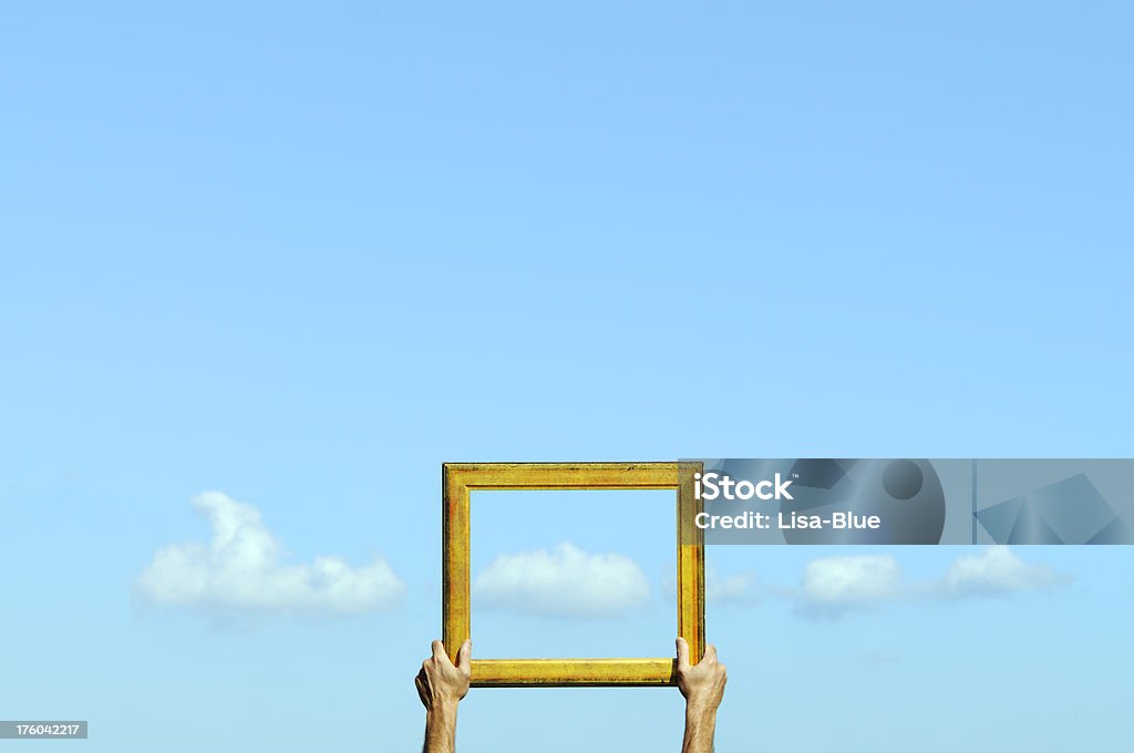 Cloud Computing.The Window of Opportunity "Man holding old frame and showing clouds.Shallow depth of field,focus on frame, blurred clouds and sky.Copyspace." Border - Frame Stock Photo
