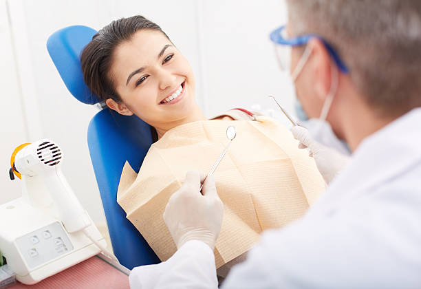 istock Female patient receiving a checkup from the dentist 176042329