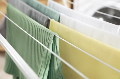 Different apparel drying on clothes airer, closeup