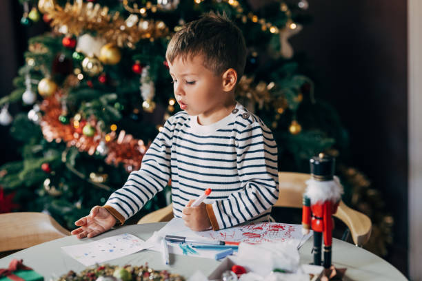 istock A Cute Baby Boy Enjoying Drawing At Christmas 1760431193