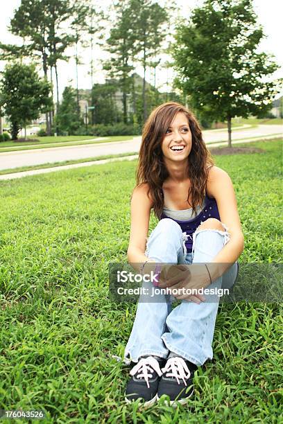 Laughing Teenage Girl Sitting In The Grass Stock Photo - Download Image Now - 16-17 Years, Adolescence, Adult