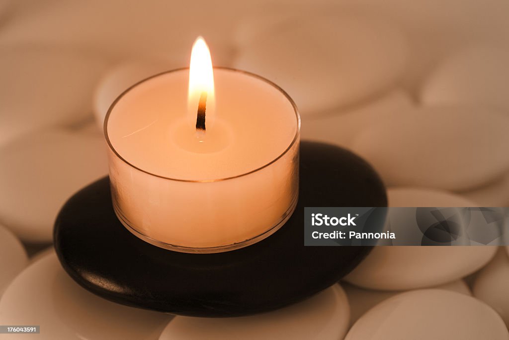 Candle on Pebbles "Candle on white and black pebbles (pebble, fire)" Beauty Stock Photo
