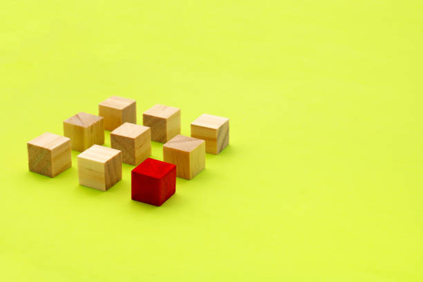 istock Red wooden cube in front of a group of lined up cubes 1760449102