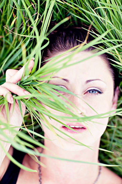 istock woman hiding behind fresh grass 176044999