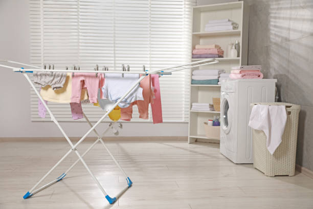 istock Clean laundry hanging on drying rack indoors 1760451740