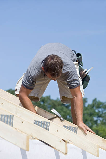 istock Builder Hammering Roof Truss Nail Against Blue Sky 176045353