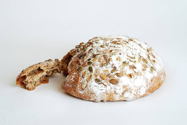 round loaf of bread with pepitas stock photo