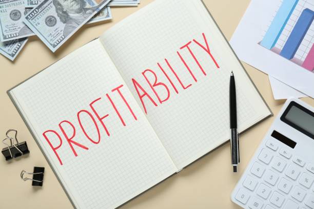 istock Notebook with word Profitability, calculator, banknotes and diagram on beige background, flat lay. Profit concept 1760472366