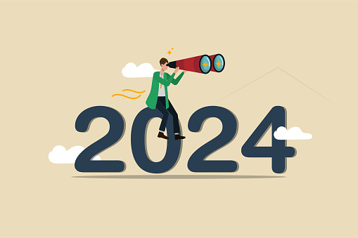 setting goals, success or achievements, the businessman is sitting on 2024 with his binoculars and is observing the future.