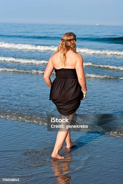 Giovane Donna Bionda Con Il Vestito Nero Da Pesca In Mare - Fotografie stock e altre immagini di Adolescente