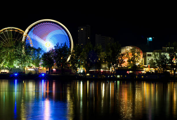 istock annual fair amusement park beside a river at night 176048917