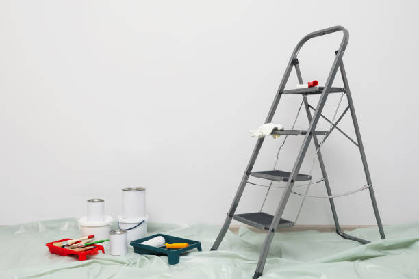 istock Metallic folding ladder and painting tools indoors, space for text 1760502646
