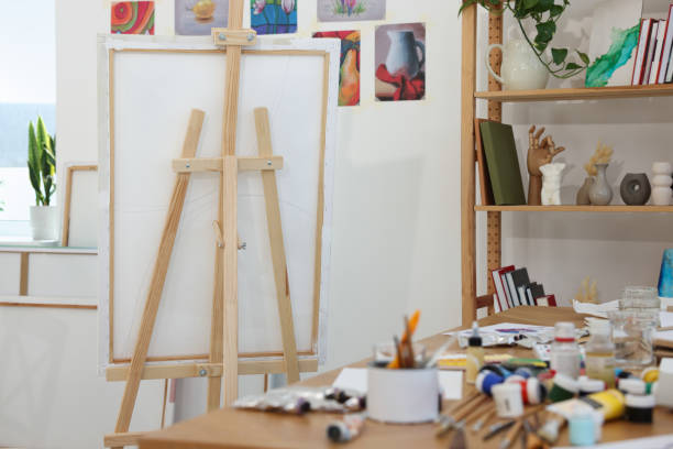 istock Wooden easel with canvas in artist's studio. Creative hobby 1760504768