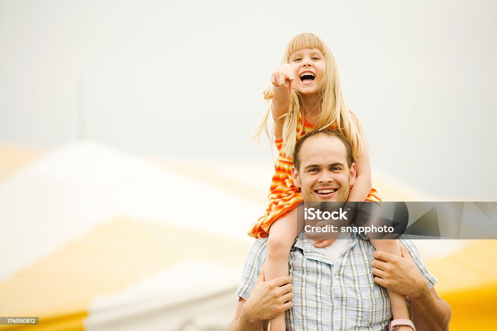 Father and Girl Child on Shoulders at Fair or Circus pointing Family Stock Photo