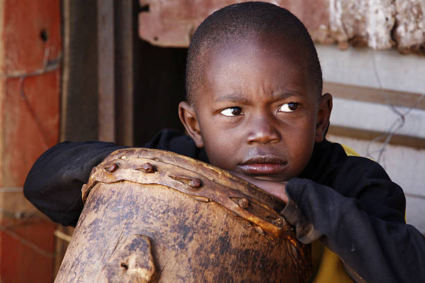 istock African rural child and drum 176050876