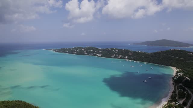 Stunning aerial view homes on mountain st. thomas magen's bay coki beach sapphire beach turquoise water waves blue sky white clouds east end red hook hills and mountains sun gleaming