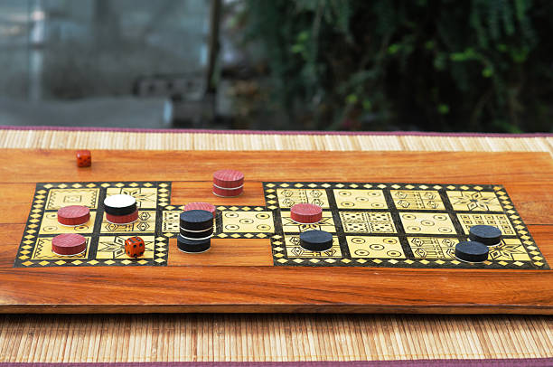old-fashioned Draughts/Checkers type game on carved wooden board