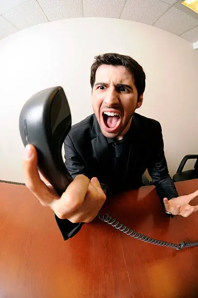 A businessman yells into a phone. Taken at Echucalypse Toronto '09.