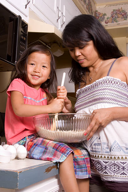 istock Little girl cooks with her Mom 176054129