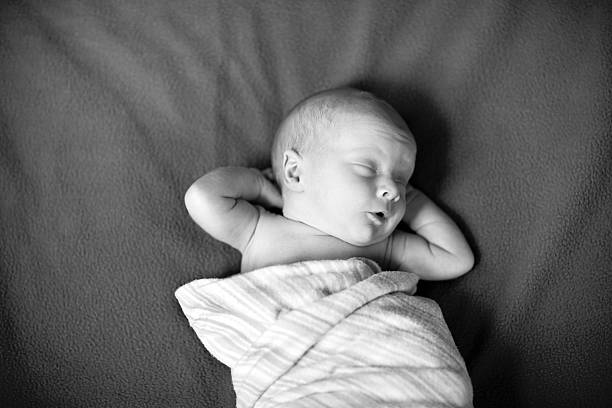 istock Tired Newborn Baby Boy Sleeping & Stretching 176054421